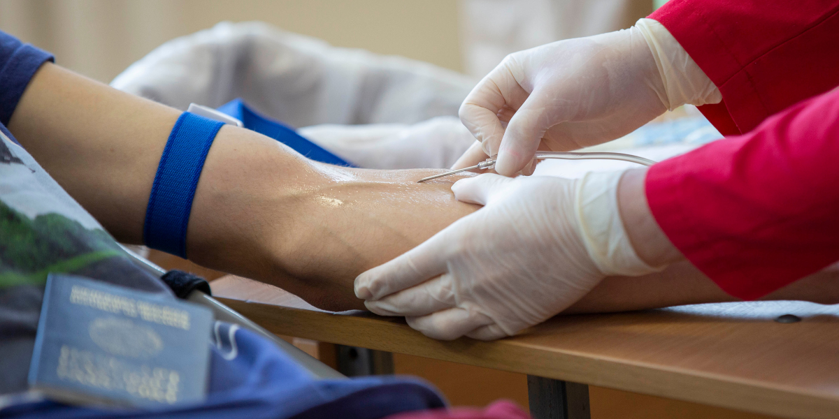 Patient receiving hydration therapy via IV drip to alleviate cold and flu symptoms, promoting faster recovery and enhanced wellness.